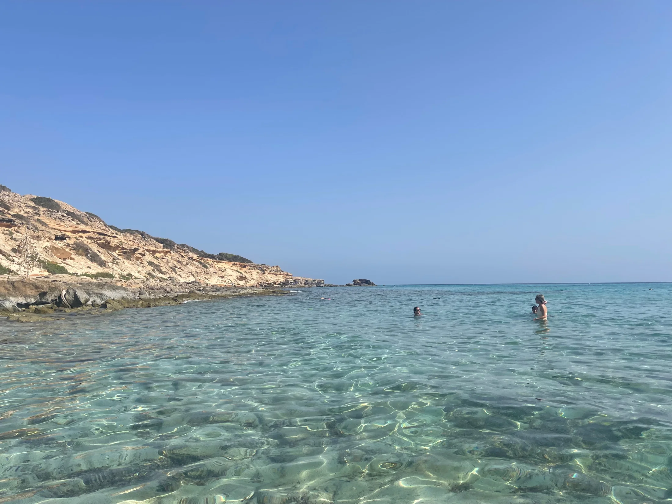 Crique rocheuse et eau cristalline à Es Arenals, côte sud de Formentera