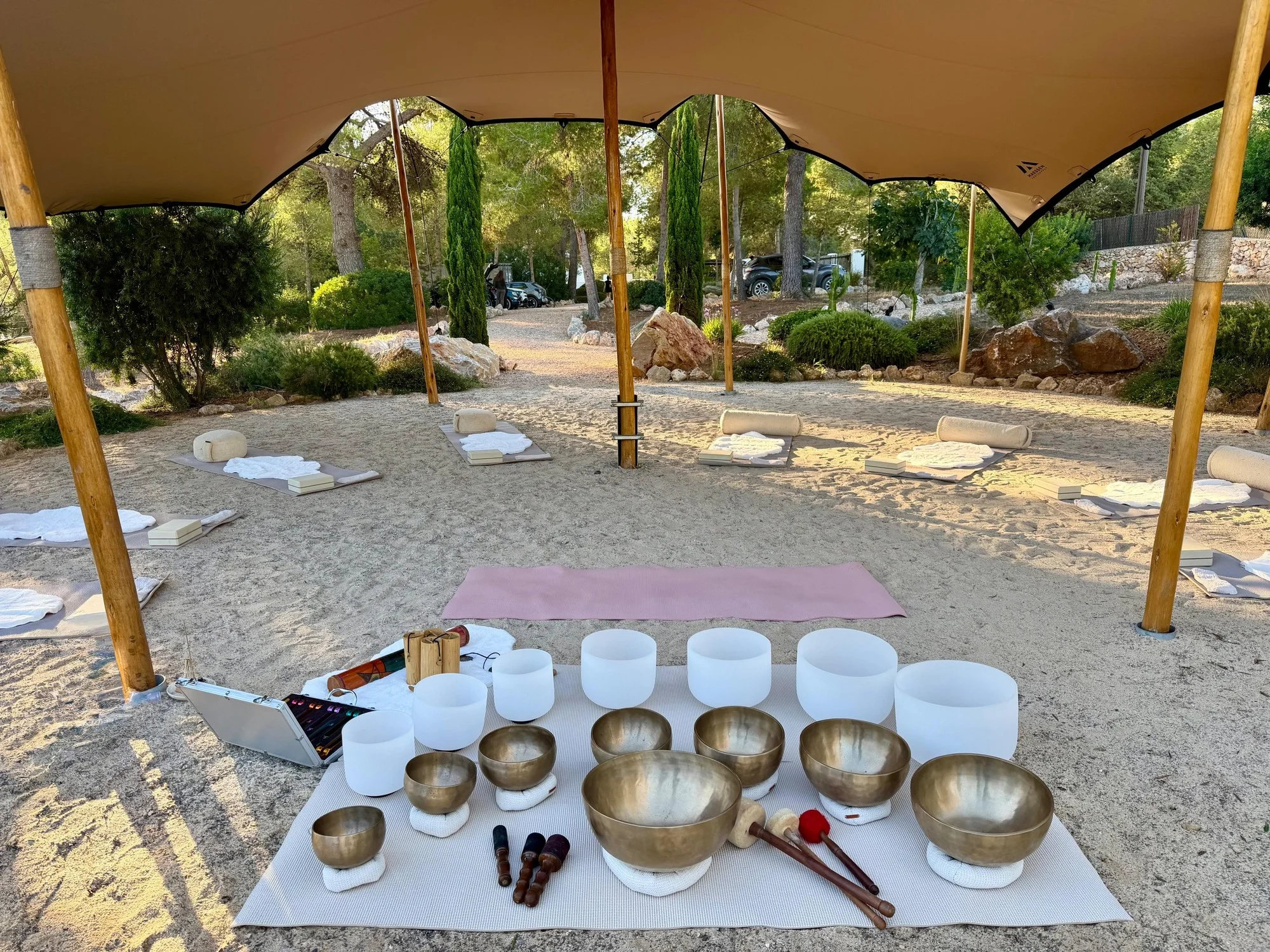 bain sonore bols chantants ibiza Bols chantants tibétains et bols de cristal installés pour un bain sonore sous une tente dans un jardin d'Ibiza